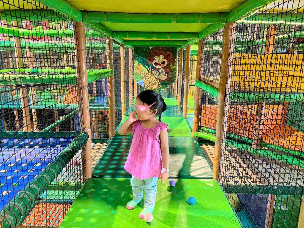Toddler at an indoor playground, enjoying Kuala Lumpur activities for families.