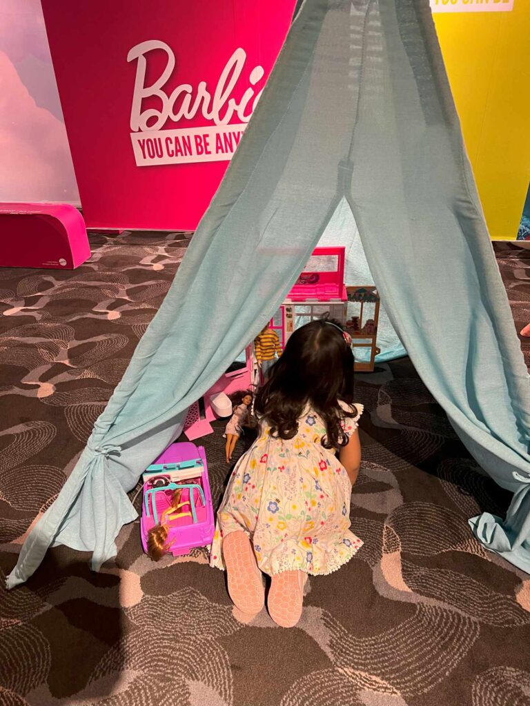 Toddler playing in a Barbie Tent at a kid-friendly cinema, one of the best Kuala Lumpur kids activities.