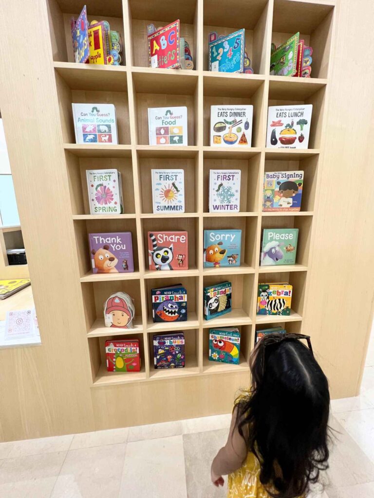 A toddler looks at the book collections at the Islamic Arts Museum Children's Library.