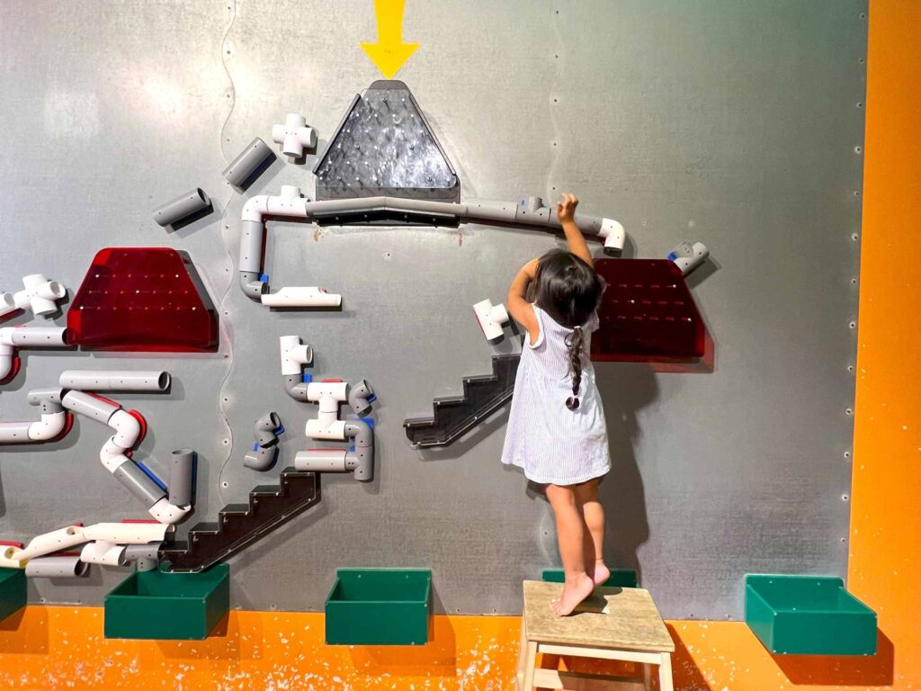 A young girl plays with an exhibit at National Science Center Malaysia.
