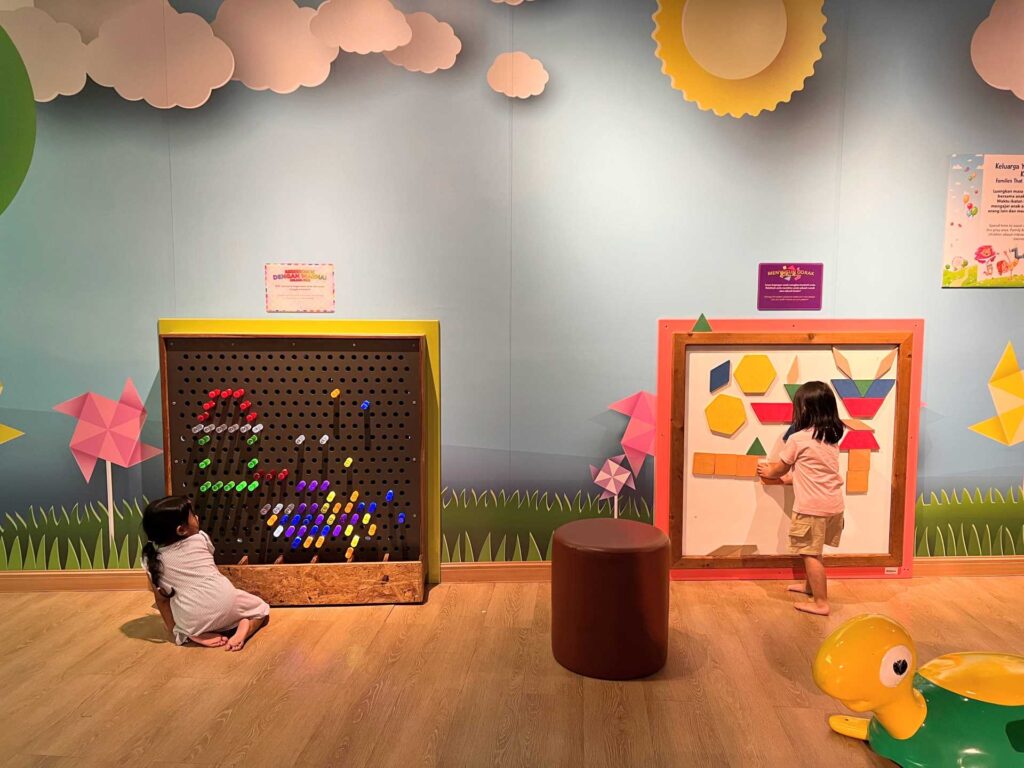 Two young girls are playing at the toddler play area in Malaysia National Science Center.