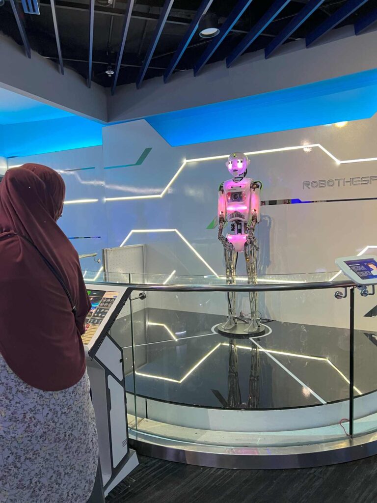 A visitor checks out a robot at the Tech Lab section in Petrosains.